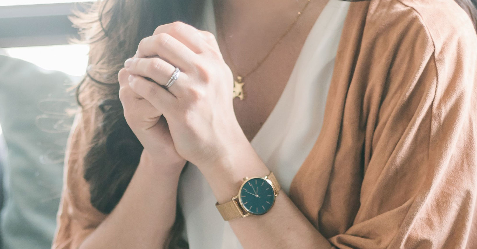 Woman with her hands clasped in prayer